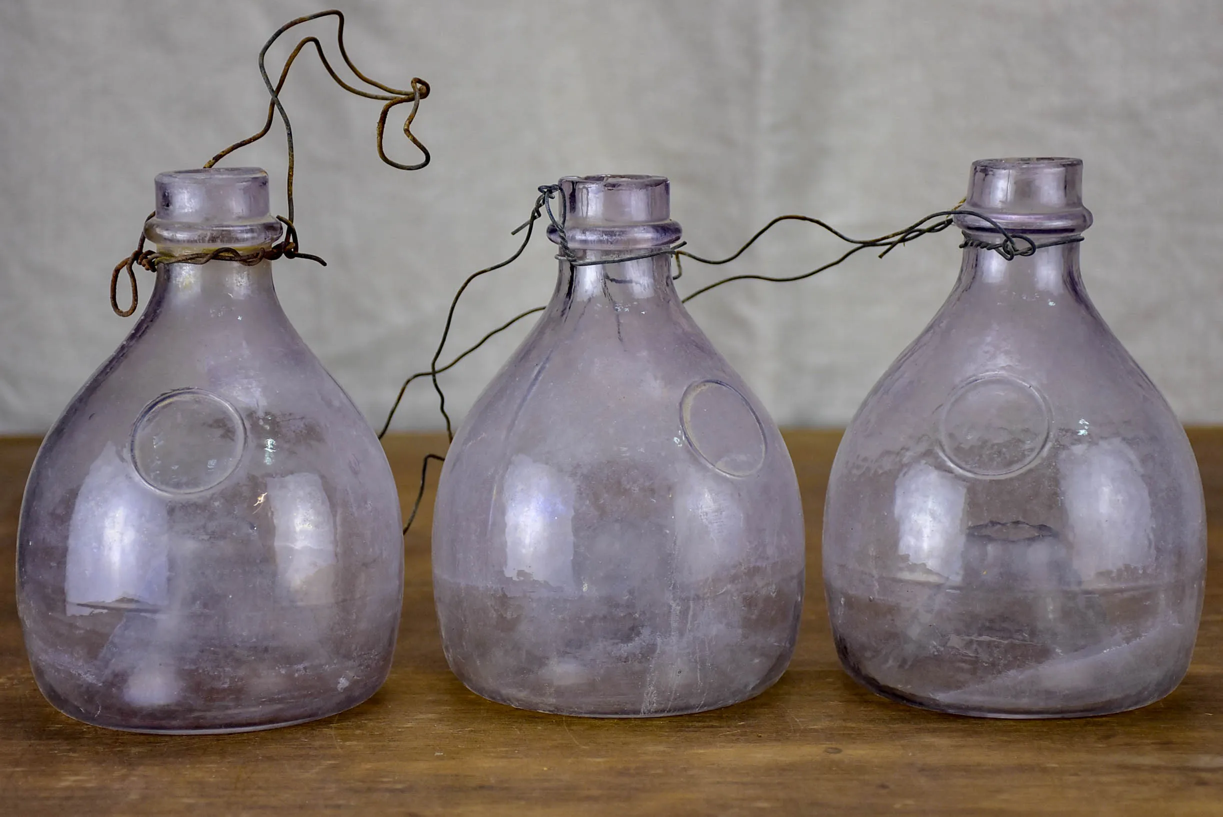 Three antique French fly-trap bottles - purple tinge